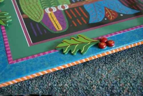 A Framed Kuna Indian Folk Art Mola from San Blas Islands, Panama in Hand Painted Frame With Wood Leaves, Glass & Double Mats. Hand stitched  Applique: Green Parrots On a Perch 20.5" X 17.5" (DFM20) WALL DECOR
