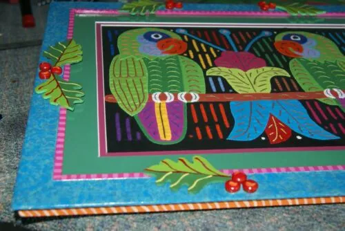 A Framed Kuna Indian Folk Art Mola from San Blas Islands, Panama in Hand Painted Frame With Wood Leaves, Glass & Double Mats. Hand stitched  Applique: Green Parrots On a Perch 20.5" X 17.5" (DFM20) WALL DECOR