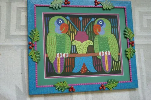 A Framed Kuna Indian Folk Art Mola from San Blas Islands, Panama in Hand Painted Frame With Wood Leaves, Glass & Double Mats. Hand stitched  Applique: Green Parrots On a Perch 20.5" X 17.5" (DFM20) WALL DECOR