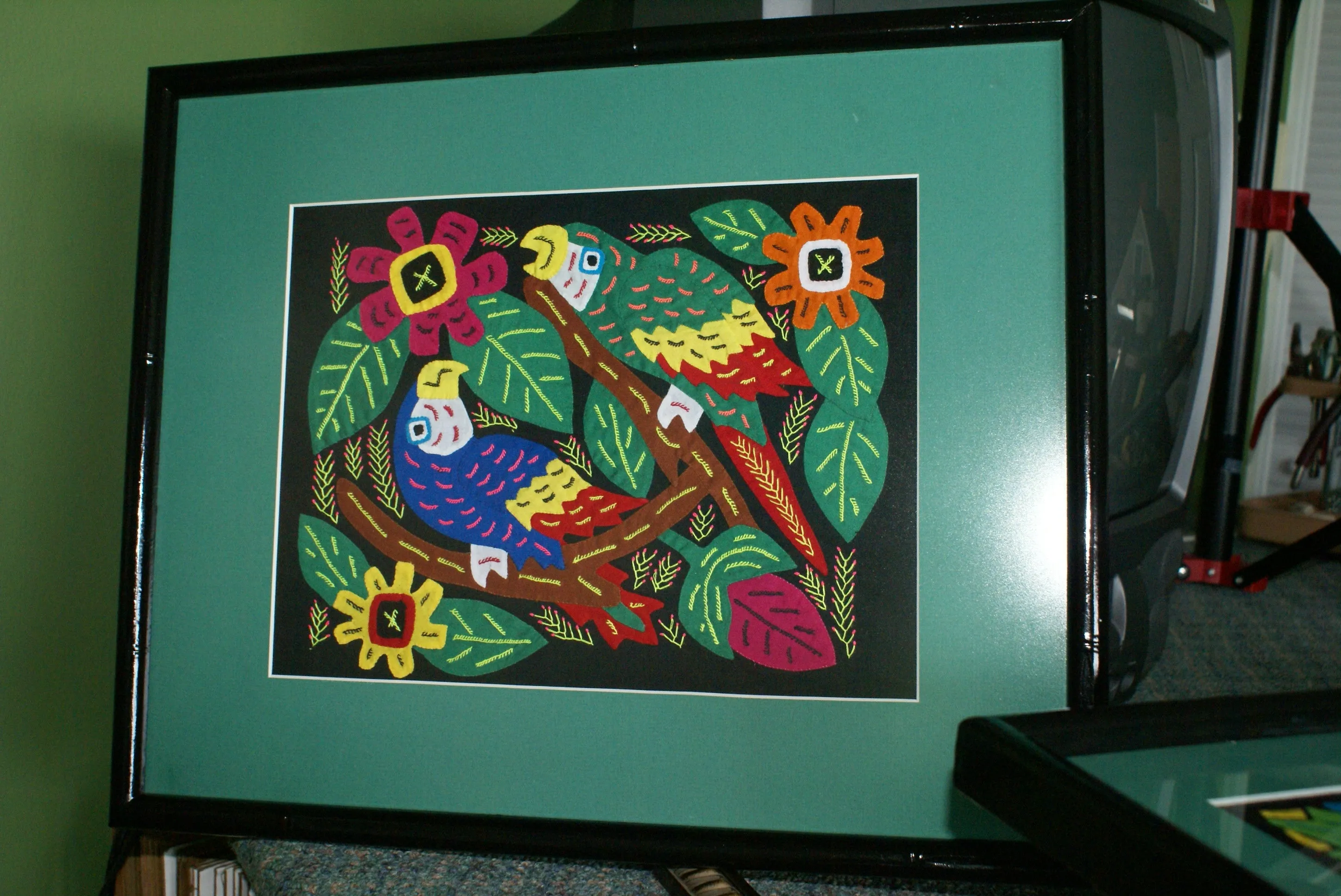 A Kuna Indian Folk Art Mola from San Blas Islands, in Custom Frame with 1 Green Mat & Non-Glare Glass : Hand stitched Textile Applique: Colorful Macaw Parrots & Hibiscus Flowers, 19" x 15" (DFM16) Wall Décor