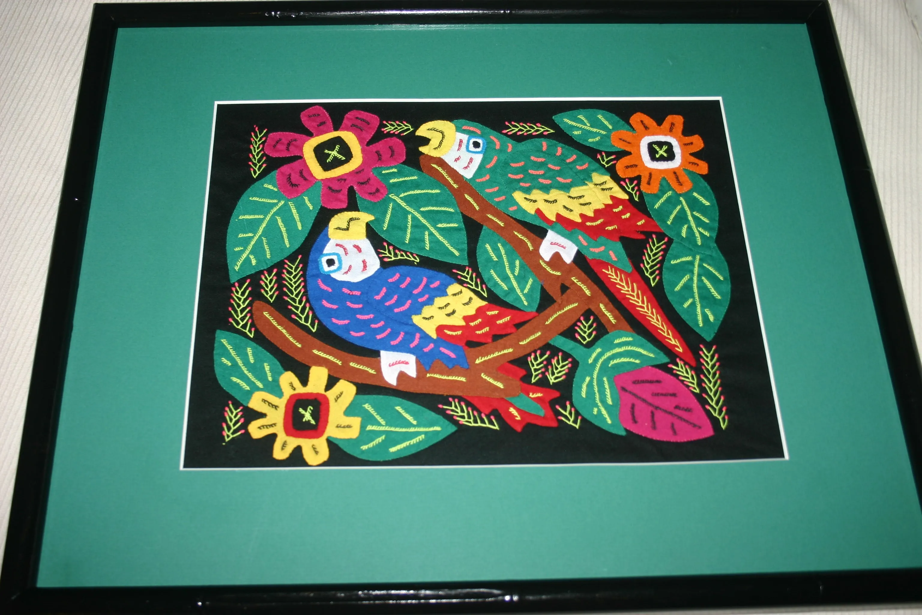 A Kuna Indian Folk Art Mola from San Blas Islands, in Custom Frame with 1 Green Mat & Non-Glare Glass : Hand stitched Textile Applique: Colorful Macaw Parrots & Hibiscus Flowers, 19" x 15" (DFM16) Wall Décor