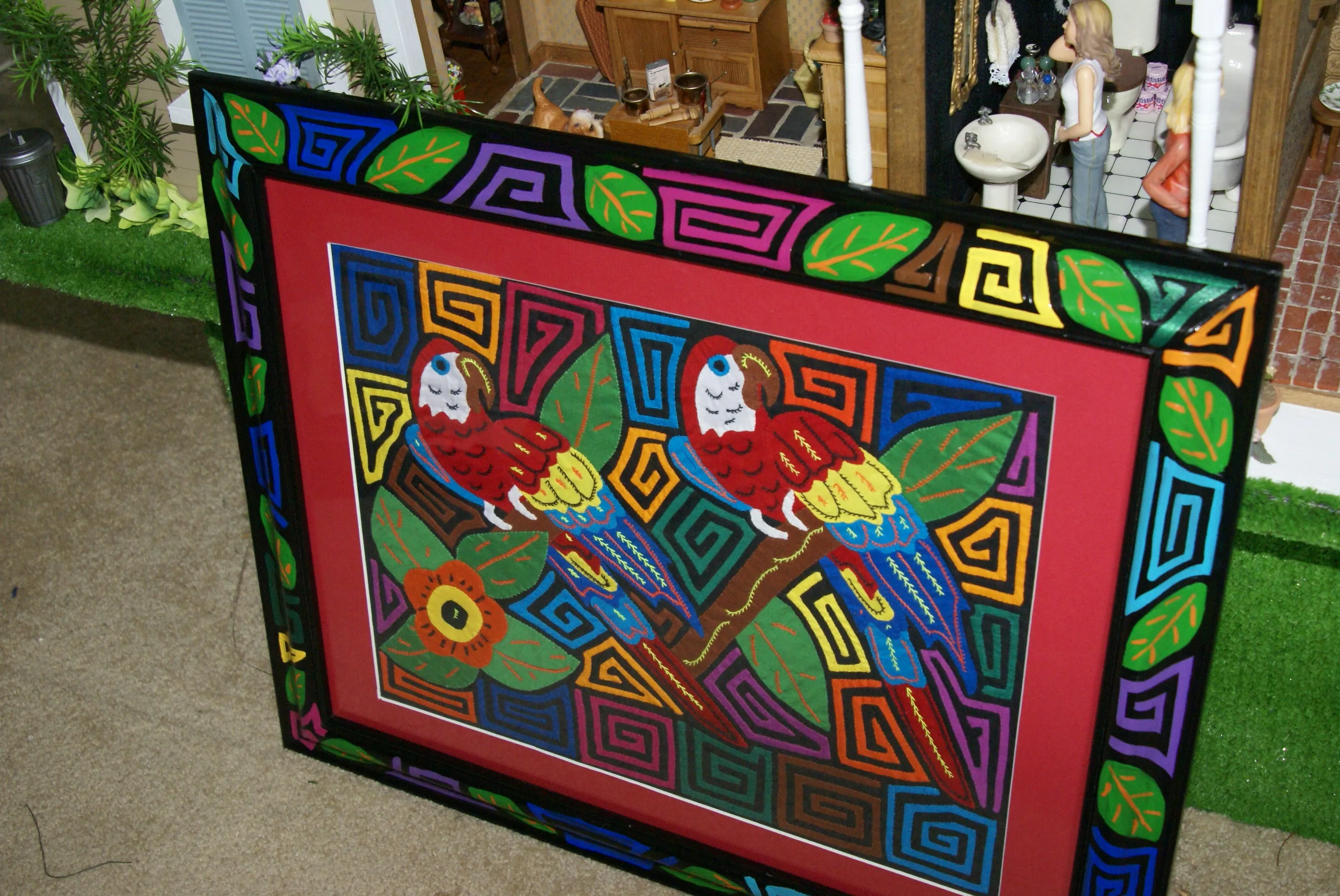 A Kuna Indian Folk Art Mola from San Blas Islands, in Custom Unique Hand Painted Signed Frame with red Mat: Hand stitched Textile Applique: Colorful Macaw Parrots & Hibiscus Flowers, 21.5" x 17" (DFM18) Wall Décor